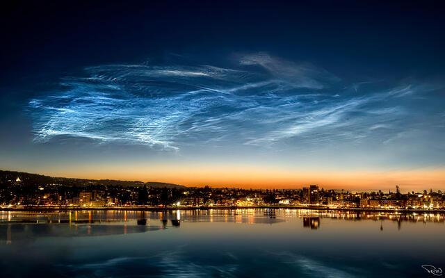 The rarest cloud in the world shimmers brightly in the predawn hour above Lake Merritt and the Oakland skyline.